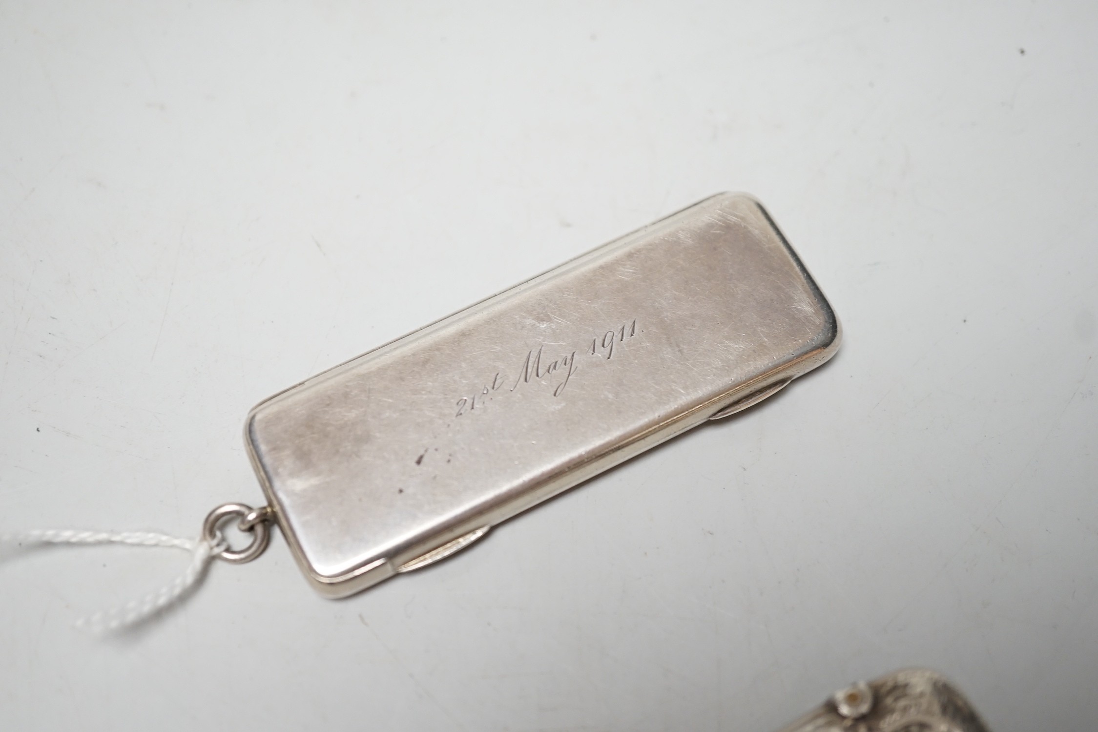 An Edwardian silver rectangular cigarette paper dispenser, maker WH, no assay office mark, circa 1908, 77mm and a silver vesta case.